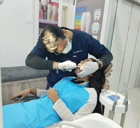 Dentist examining a patient's teeth at Anuraag Dental Care & Implant Centre in Jabalpur
